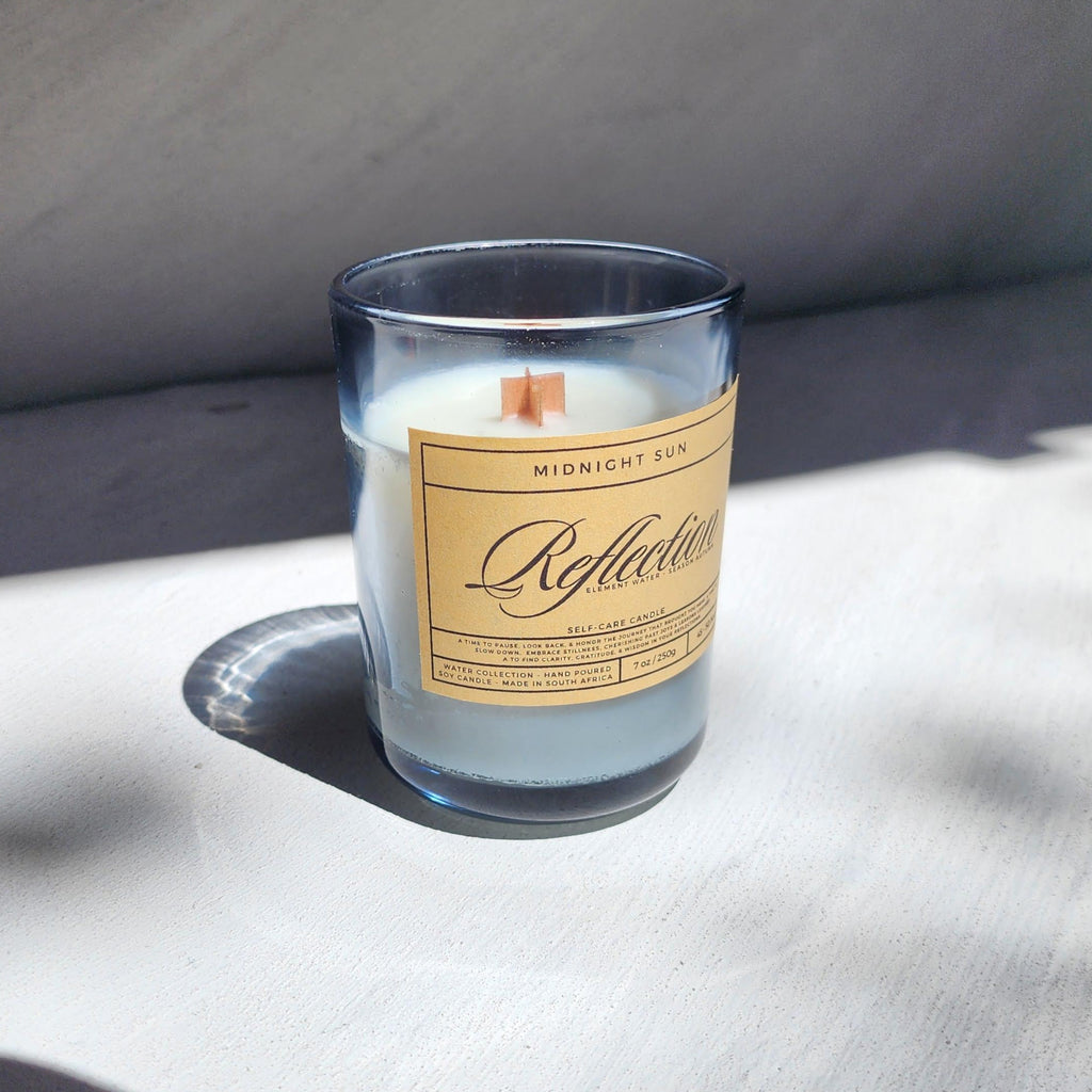 Candle with a label on a textured surface