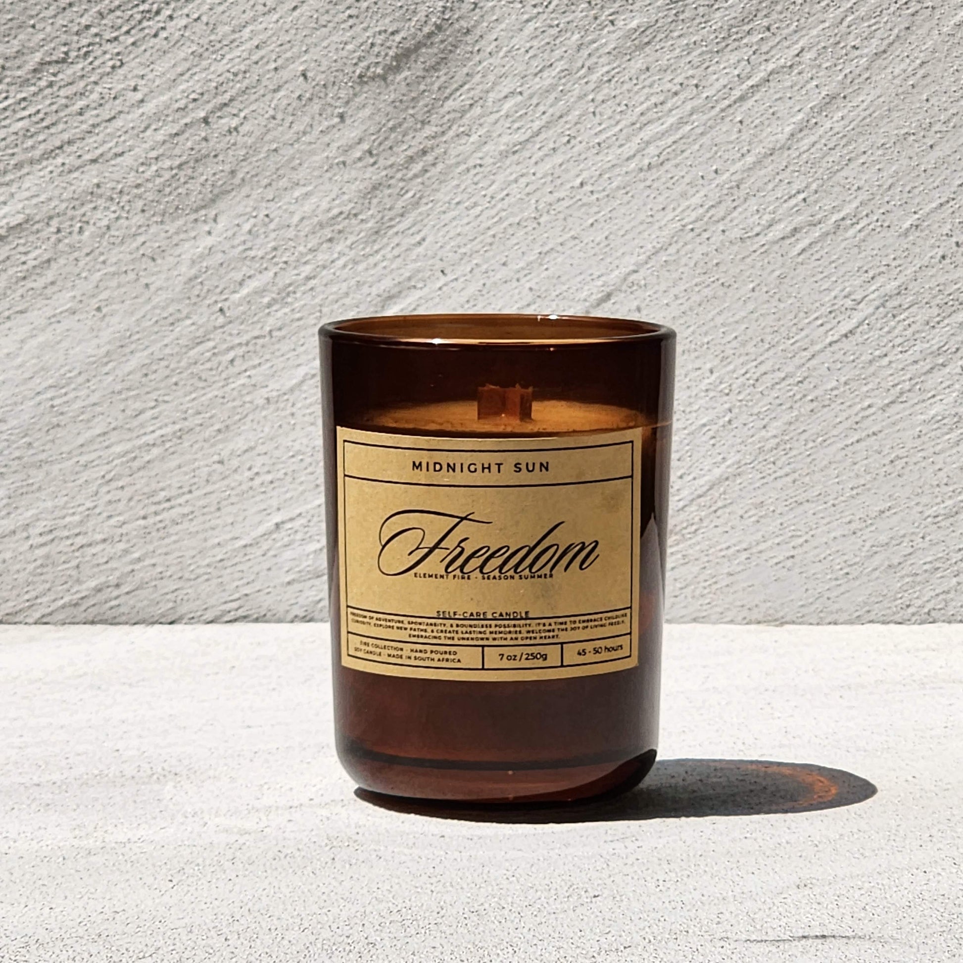 Candle with a label on a textured surface